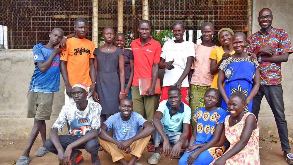 Members of Happy Poultry Group posing outside their poultry house, built with support from ForAfrika