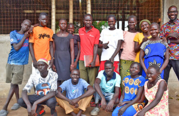 Members of Happy Poultry Group posing outside their poultry house, built with support from ForAfrika